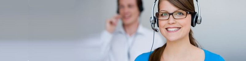 Two service consultants wearing telephone headsets