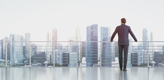 Businessman looking out over a city skyline